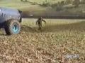 farmer unclogs fertilizer tank