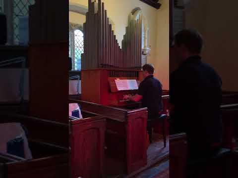 Sam playing the organ at St Germans church germansweek
