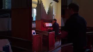 Sam playing the organ at St Germans church germansweek