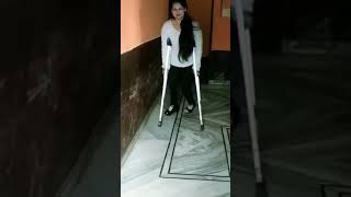 Short Leg Polio Woman Crutching.