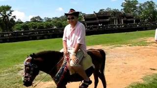 Riding A Horse In Siem Reap, Cambodia In Front Of Angkor Wat