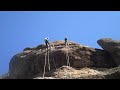 Evan Gao rappels down a cliff in Pinnacle National Park