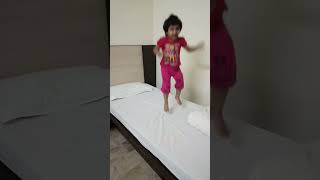 Little Girl Enjoying Jumping On The Bed Jumping On The Bed