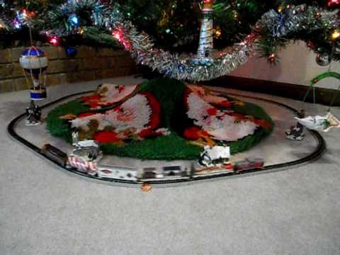 scale christmas train under tree during holidays - YouTube