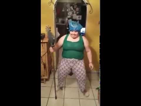 Lady dancing with a broom to a Puerto Rican song