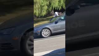 Woman Jumps On Vehicle Hood Right Before It Drives Off