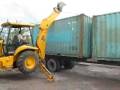 Shipping Containers in Costa Rica being unloaded with a Backhoe