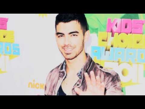 Miley Cyrus and Joe Jonas hugging at the KCAs 2011