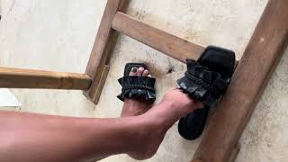 Beautiful Girl Dangles Sandals Under Table