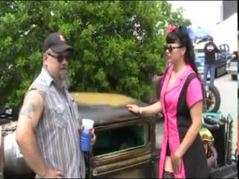Rust Queens model Chez talks to a car guy at Beatersvilles about his Retro