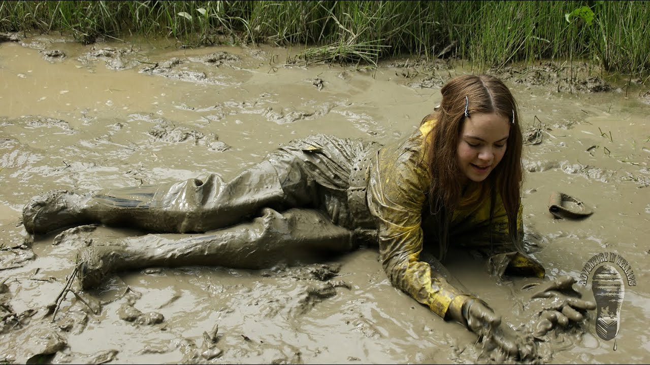 Nude girl in pool of mud