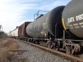 BNSF slow eastbound train with horn at crossing