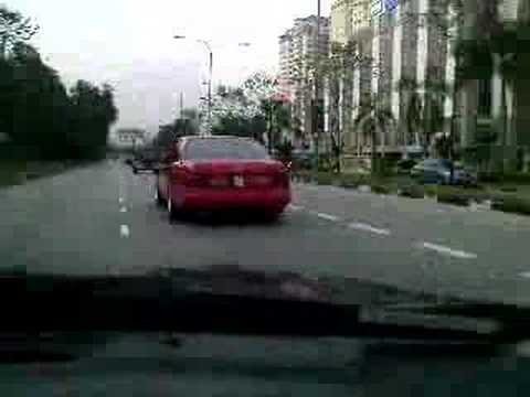 A red W124 coupe rolling in Damansara