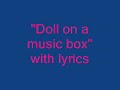 Doll on a music box with lyrics