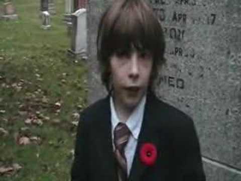 flanders field poem. A young boy recites the poem In Flanders Fields while standing in front of a grave stone dedicated to soldiers who died in WWI.