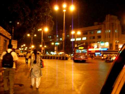 One can see street light on road people running for bus the famous Metro