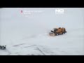 Drone footage shows snow-covered US cities, snow plows at work