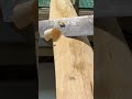Artisan Hand Carving A Sleek Wooden Handle Using Steel