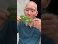 Grandpa plays the game of blowing bubbles from leaves