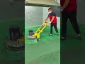 Professional Worker Sanding and Levelling Epoxy Floor
