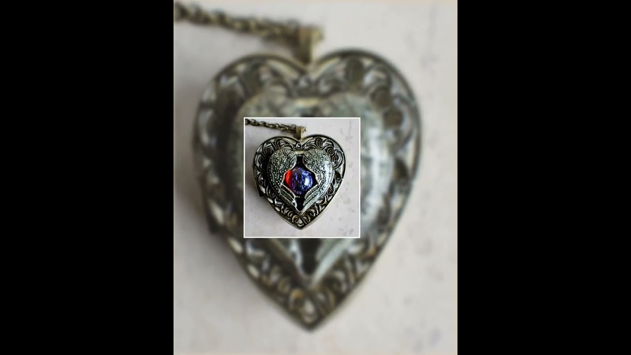 Angel wing music box locket, heart locket with music box inside with dragons breath cabochon.