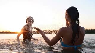Happy wet girls in bikini run into sea and play splashing water to each other on sunset.#shorts