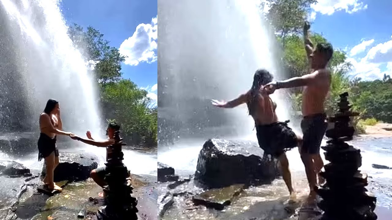 Moment woman slips and falls during romantic waterfall proposal