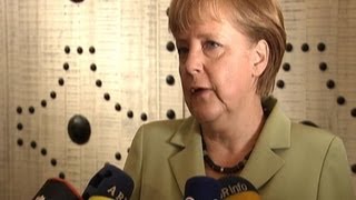 Merkel says Greece must implement its commitments