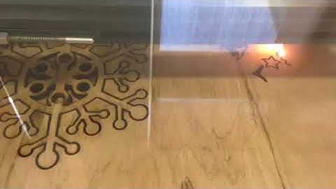 Laser cutting wooden snowflake ornaments