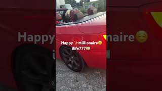 A red BMW convertible (“droptop”) has a classic sports-car vibe—top down, bright red paint, love