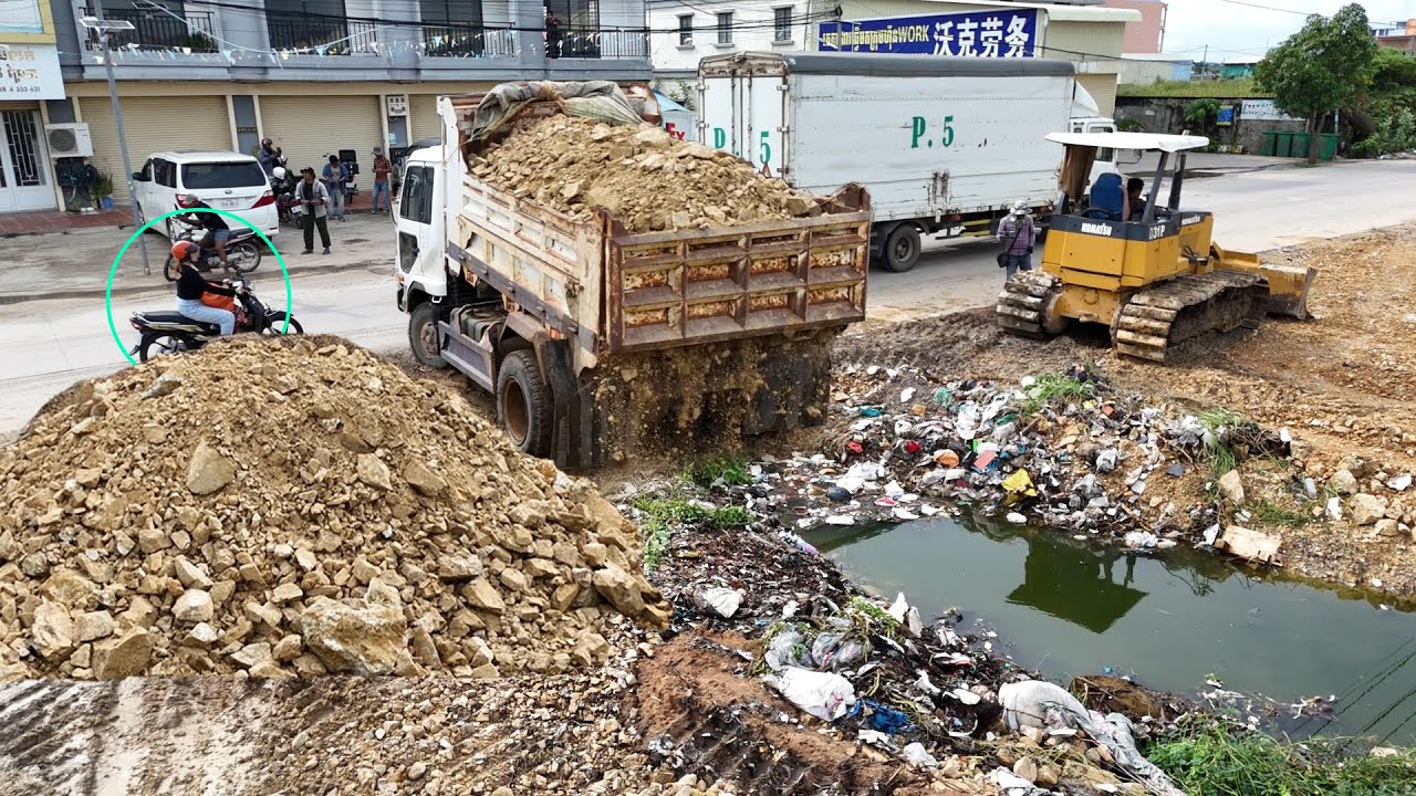 OPERATOR DUMP TRUCK WITH EXPERT DOZER FILLING LAND HUGE POND