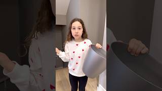 Kids learn to throw trash in a trash bin