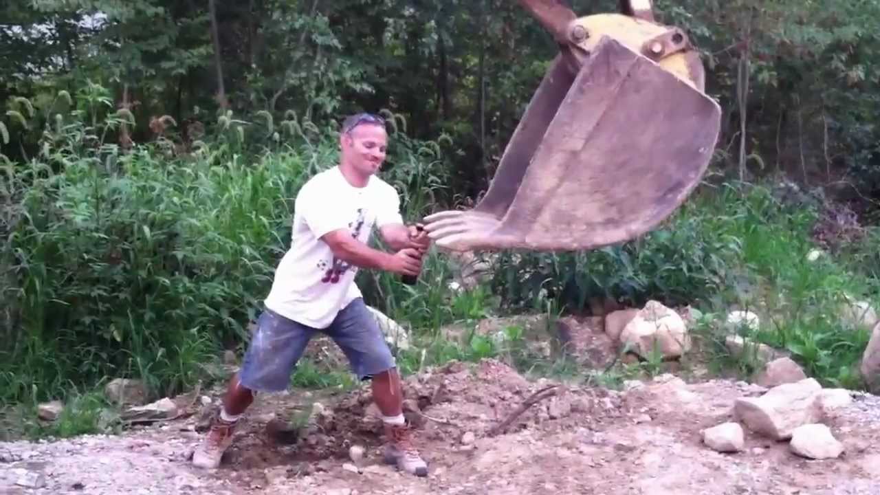 How to open a beer bottle with a backhoe - YouTube