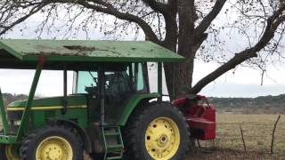 John Deere Shaking pecan Nuts from Texas Pecan Trees in San Saba Texas