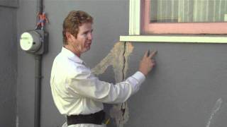 Caulking with stucco to repair big cracks in walls.