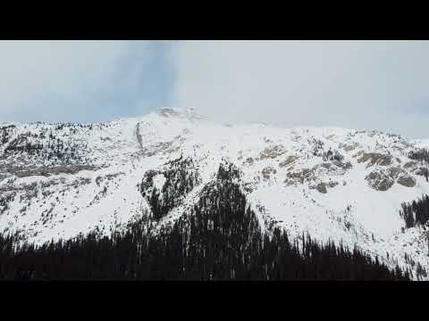 [Free Stock Footage] Snow covered Mountain above forest - Canada - Winter - 4k Drone Footage