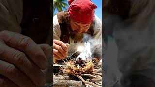 A pirate sharpening his cutlass with a whetstone while watching the horizon