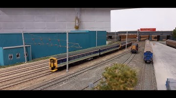 Dallam N gauge layout. VWC Mk3 Push pulls pass at Dallam Sidings.