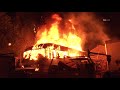 Fire consumes a 30ft RV and damages an outbuilding in Pacoima, California.
