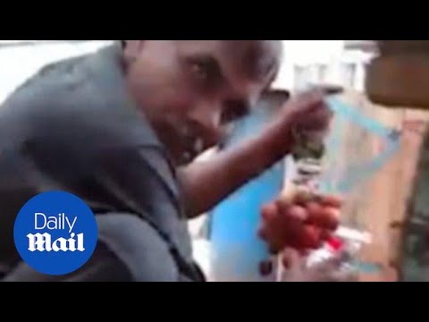 Shocking moment street trader spotted SPRAY PAINTING grapes red