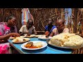 Cooking  african  traditional village food for lunchokra stew with corn flourafrican village life