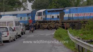 Southern Highways and Indian Railway traffic intersection in Karnataka, on a rainy day in the Ghats