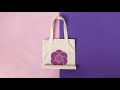 Tote bag in stop motion rolling over a pink and purple background a13667