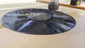 Cutting a vinyl record into a guitar pick guard.