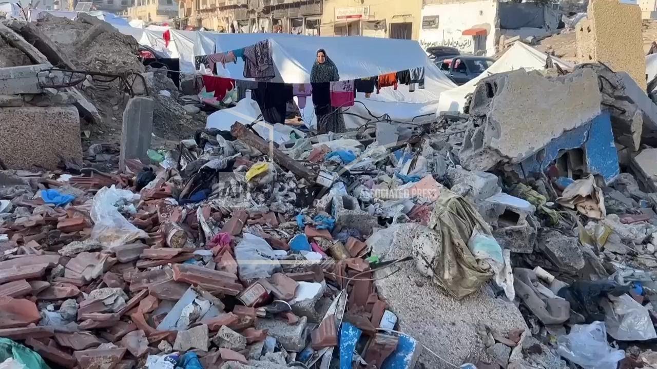 Displaced residents relocate to Gaza City and live in tents among piles of rubbish and rubble
