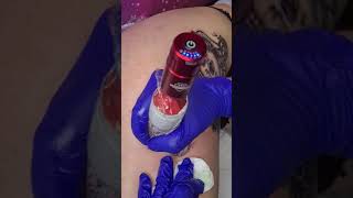 Girl thigh tattoo, snake, flowers and skull.  instrumental wutang clan