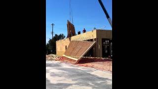 Demolition of damaged Certified Pre-Owned Ford building under construction