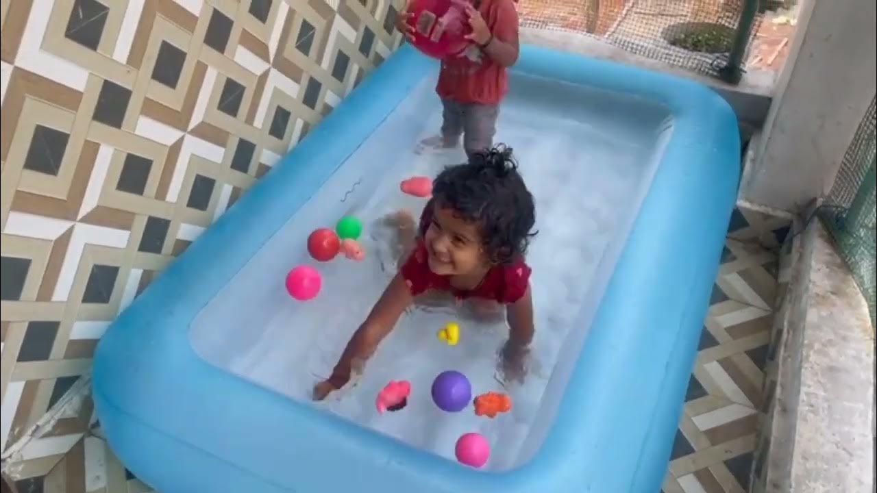 kids filling air in intex swimming pool bath tub play area water