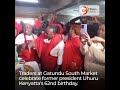 Traders at Gatundu South Market celebrate former president Uhuru Kenyatta