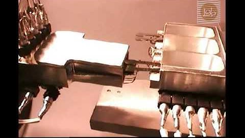 Automated tool changer for robotic micro-assembly